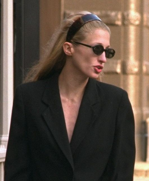 Carolyn BessetteKennedy wearing a blazer sunglasses and headband